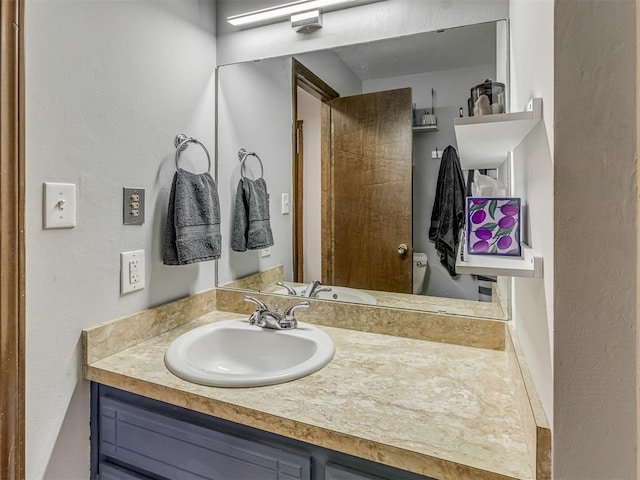 bathroom featuring toilet and vanity