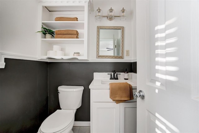 bathroom with tile patterned floors, vanity, and toilet