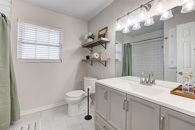 bathroom with toilet, tile patterned floors, walk in shower, and vanity