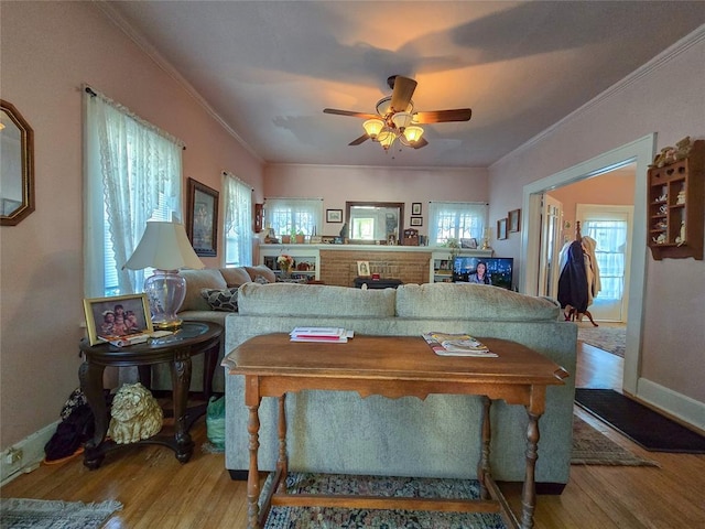 interior space featuring wood-type flooring, ceiling fan, and ornamental molding