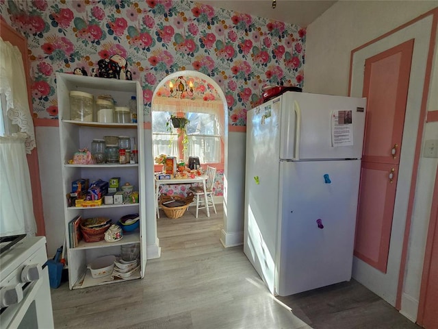 kitchen with white refrigerator and light wood-type flooring