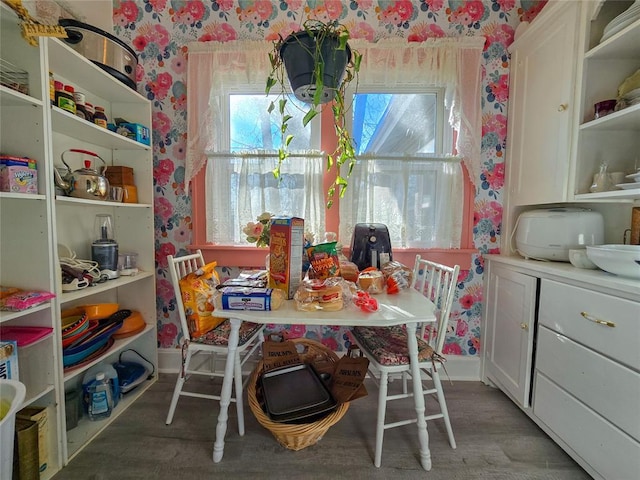 dining space with wood-type flooring