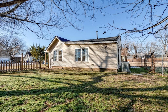 back of house with a lawn