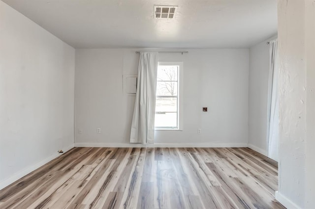 empty room with light hardwood / wood-style flooring