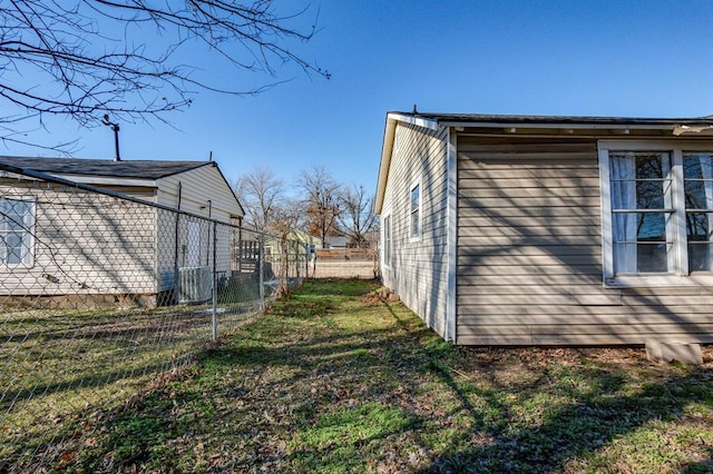 view of side of home featuring a yard