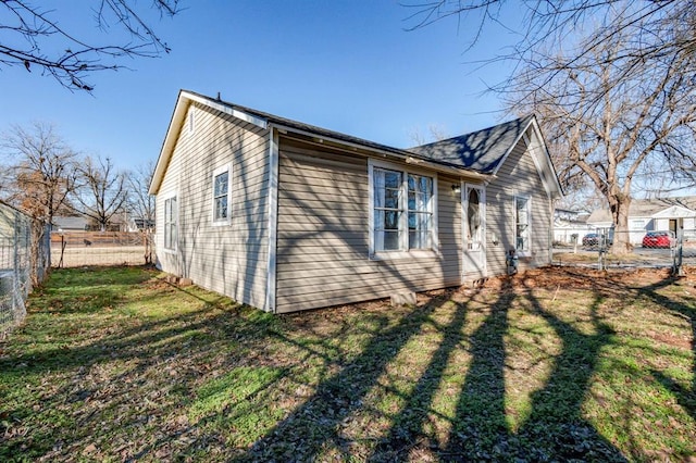 view of side of home with a yard