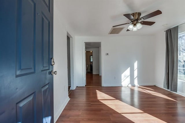 spare room featuring ceiling fan and dark hardwood / wood-style flooring