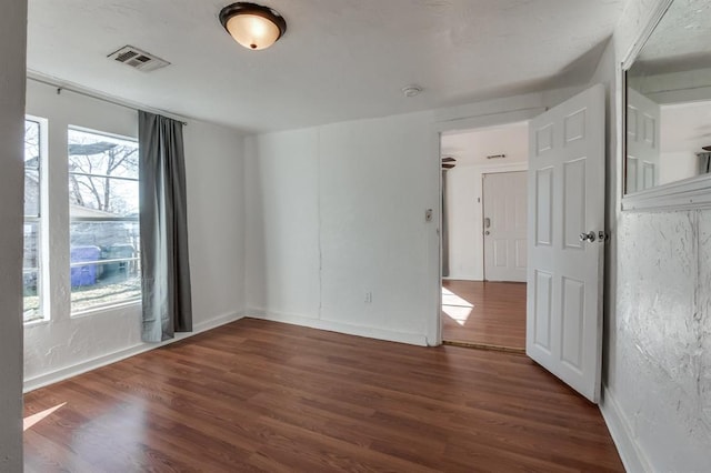 spare room with dark hardwood / wood-style flooring