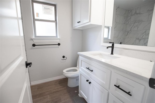 8108 NW 154th St, Edmond, OK 73013 - bathroom with vanity, toilet, wood finished floors, baseboards, and a shower