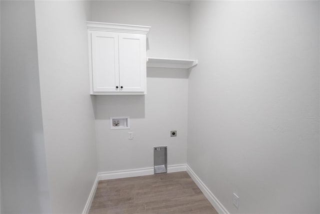 8108 NW 154th St, Edmond, OK 73013 - laundry room with electric dryer hookup, hookup for a washing machine, light wood-style flooring, cabinet space, and baseboards