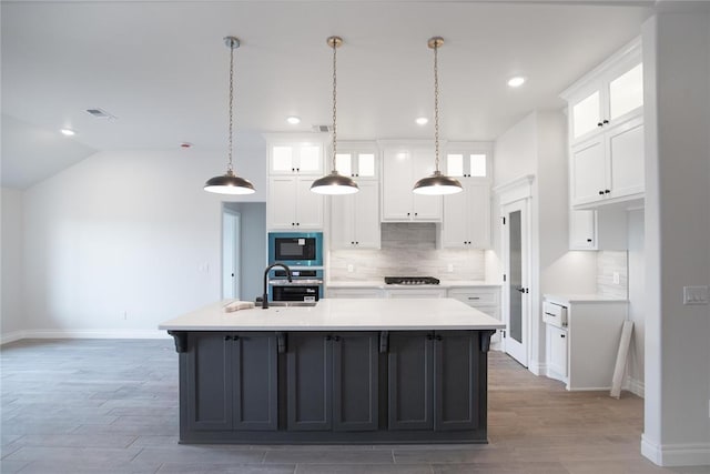 8108 NW 154th St, Edmond, OK 73013 - kitchen with a sink, appliances with stainless steel finishes, white cabinetry, decorative backsplash, and baseboards