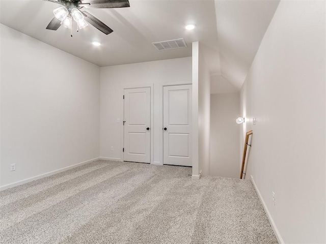 empty room with ceiling fan, carpet, and vaulted ceiling