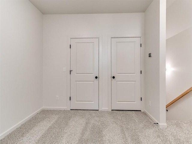 unfurnished bedroom featuring light carpet