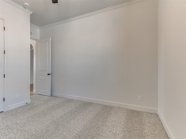 unfurnished room with crown molding and light carpet