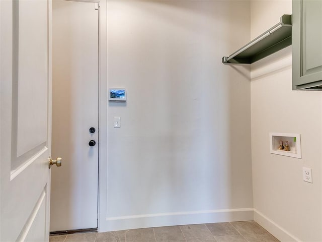 laundry area with cabinets, hookup for a washing machine, and light tile patterned flooring