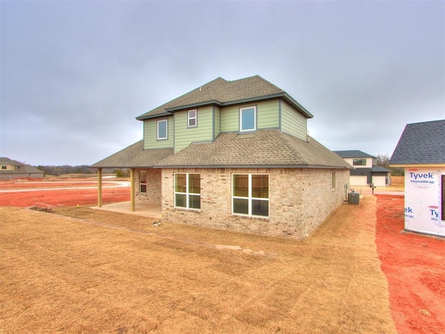 back of house with central AC and a patio