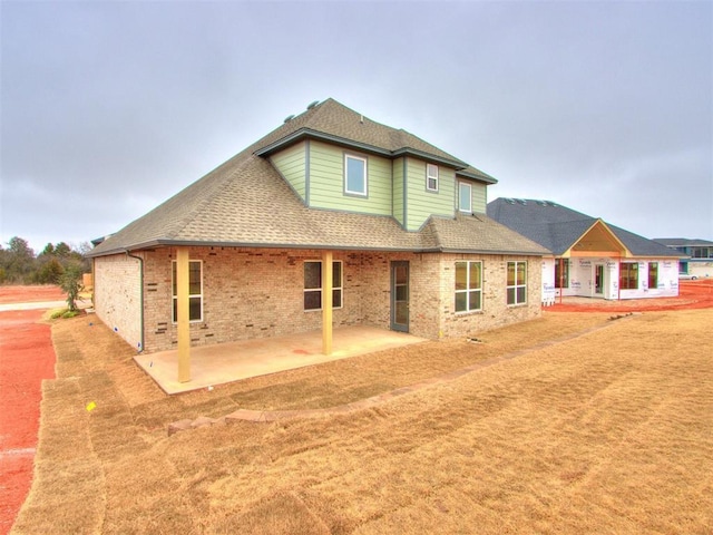 back of property with a patio