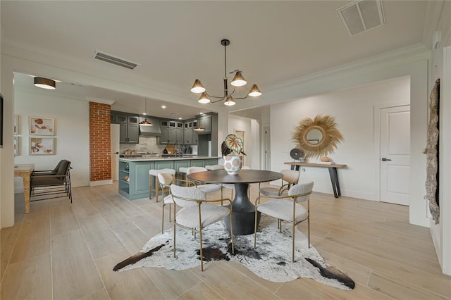 dining area featuring an inviting chandelier and crown molding