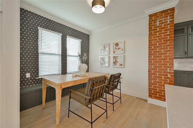 dining room with crown molding and light wood-type flooring