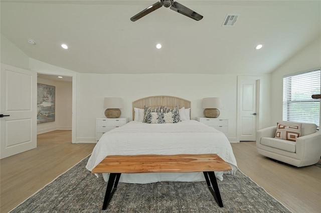 bedroom featuring hardwood / wood-style floors, vaulted ceiling, and ceiling fan