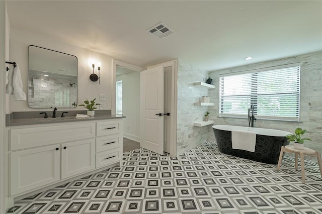 bathroom featuring shower with separate bathtub and vanity