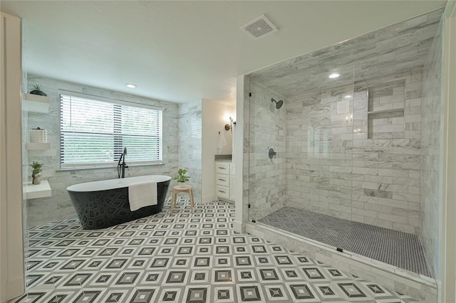 bathroom featuring plus walk in shower and tile patterned floors