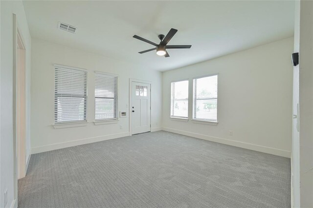 carpeted empty room featuring ceiling fan