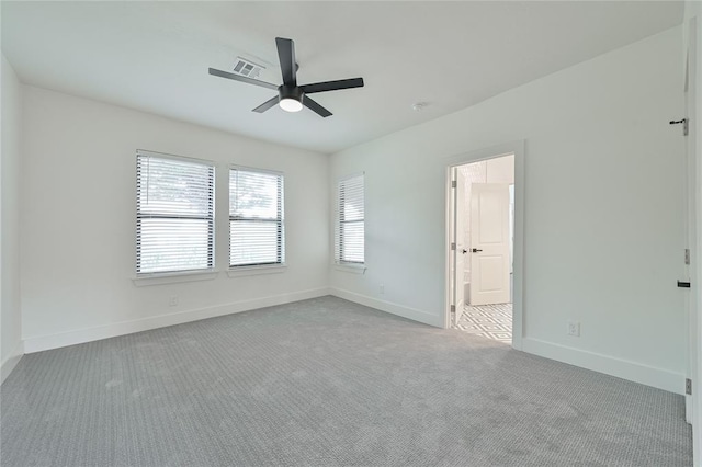 unfurnished room featuring light colored carpet and ceiling fan