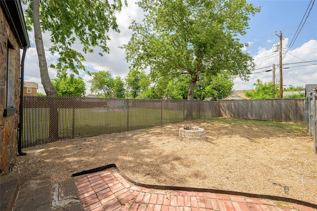 view of yard with an outdoor fire pit