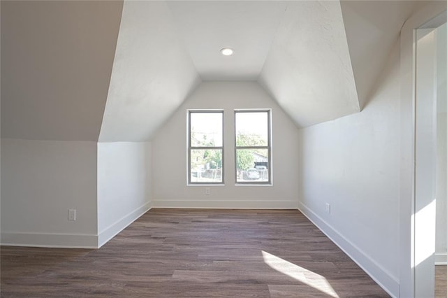 bonus room with dark hardwood / wood-style floors and lofted ceiling