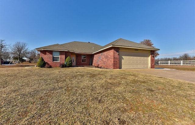 ranch-style home featuring a front yard and a garage