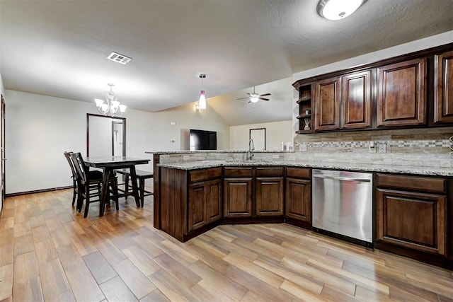 kitchen with dishwasher, sink, tasteful backsplash, ceiling fan with notable chandelier, and dark brown cabinetry