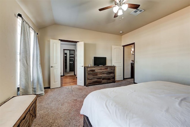 bedroom with carpet floors, ceiling fan, and vaulted ceiling