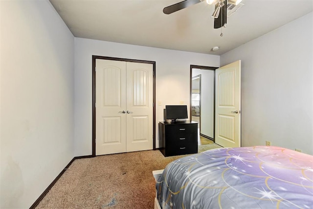 bedroom featuring ceiling fan, a closet, and carpet