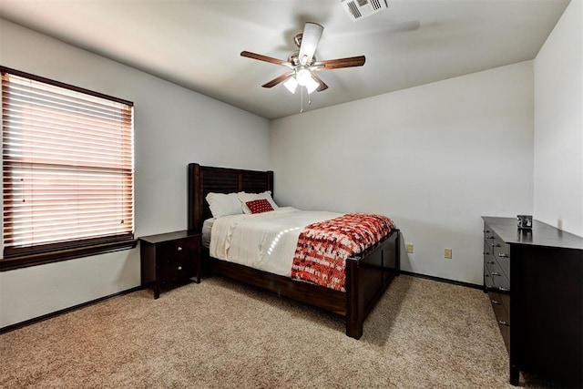 bedroom with ceiling fan and light colored carpet