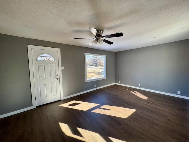 foyer entrance with dark hardwood / wood-style floors, ceiling fan, and a textured ceiling