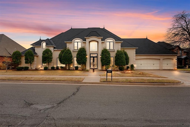 french country style house with a garage