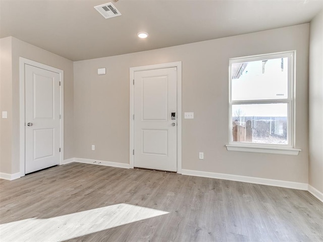 spare room featuring light hardwood / wood-style floors