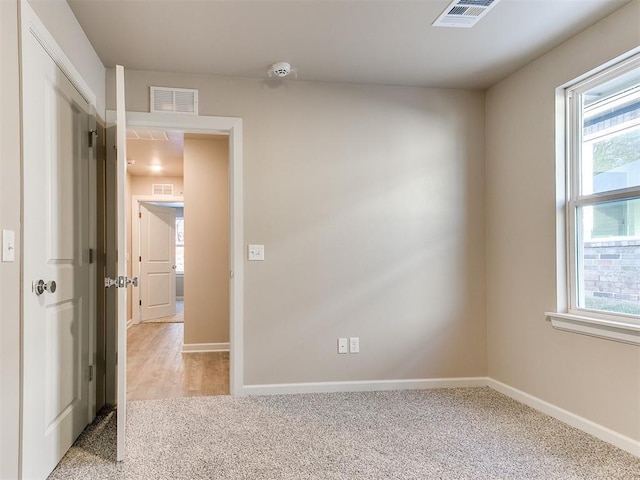 empty room featuring light carpet