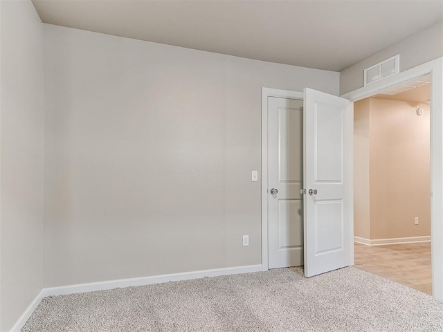 unfurnished bedroom with light colored carpet