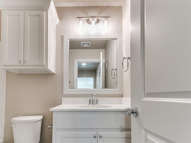 bathroom featuring toilet and vanity