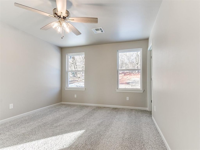 carpeted empty room featuring ceiling fan