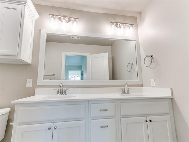 bathroom featuring toilet and vanity