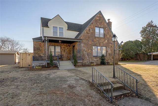 view of front of property with a porch and a storage unit