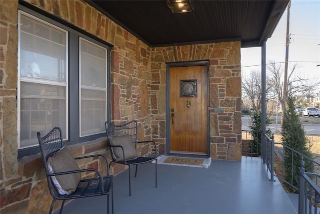 view of exterior entry with covered porch