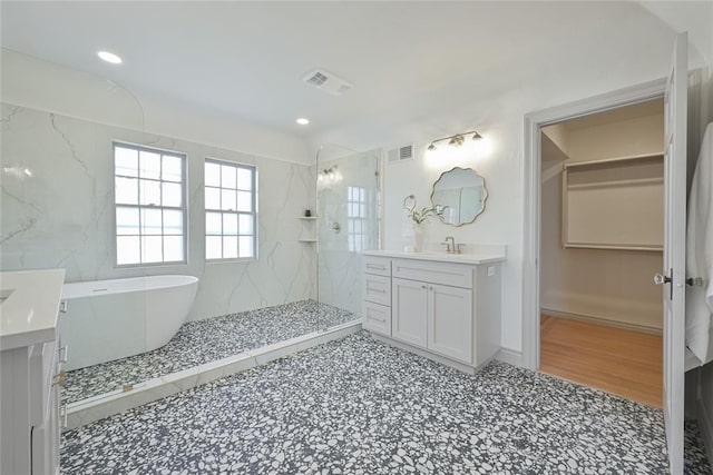 bathroom with vanity and separate shower and tub