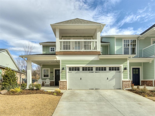 view of front facade with a garage, a balcony, and covered porch