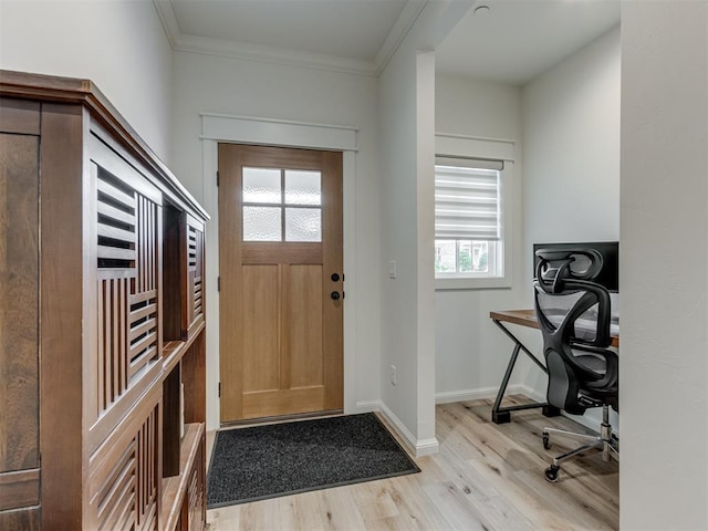 foyer featuring crown molding and light hardwood / wood-style floors