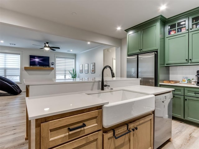 kitchen featuring ceiling fan, sink, appliances with stainless steel finishes, and green cabinets