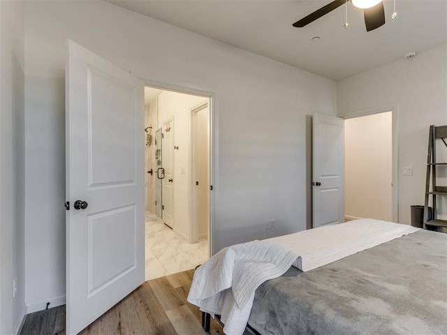 bedroom with ceiling fan, connected bathroom, and light hardwood / wood-style flooring